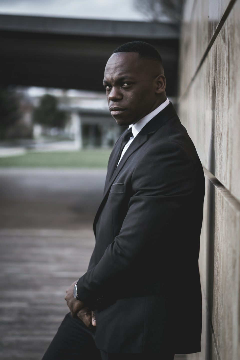 Daniel in a dark suit, looking out over the city